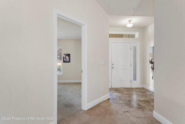 view of carpeted foyer entrance