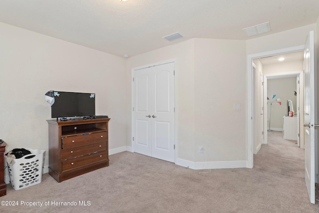 carpeted bedroom featuring a closet