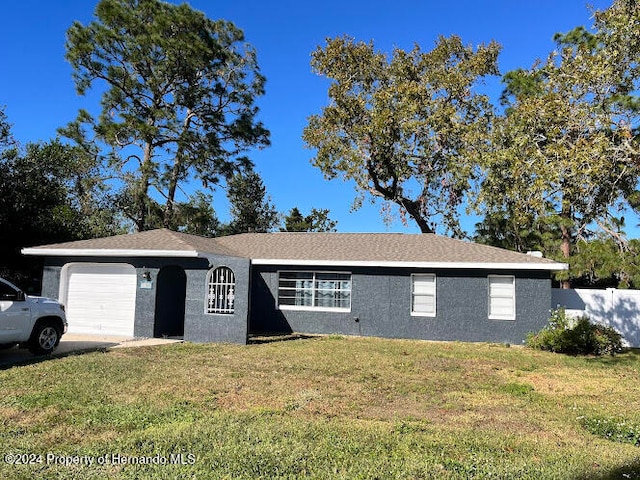 single story home with a front lawn and a garage