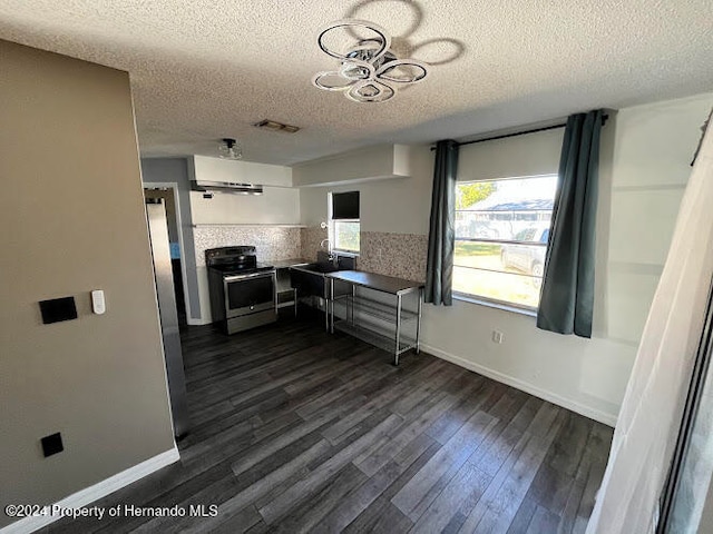 kitchen featuring decorative backsplash, a textured ceiling, stainless steel range, dark hardwood / wood-style flooring, and white cabinetry