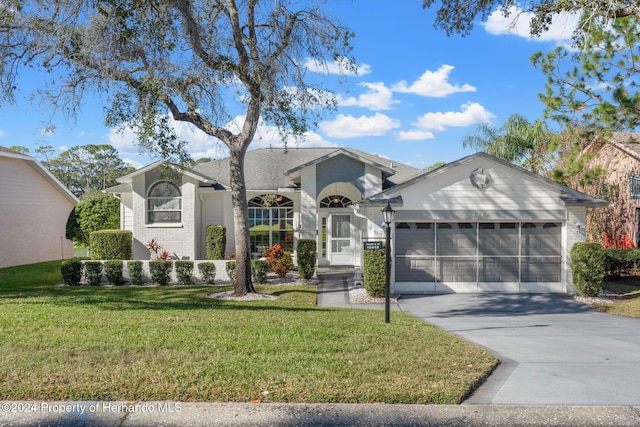 single story home with a garage and a front yard