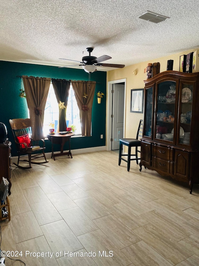 living area featuring ceiling fan