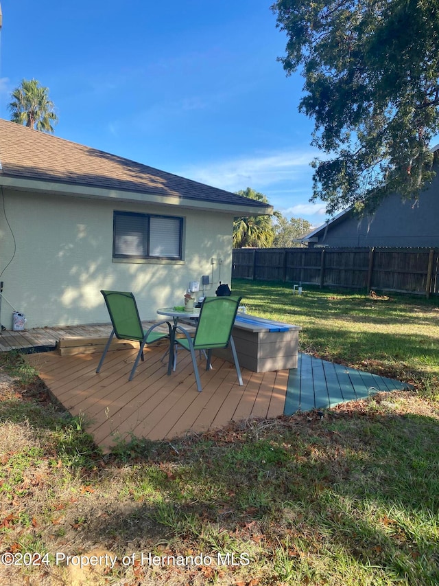 wooden deck featuring a yard