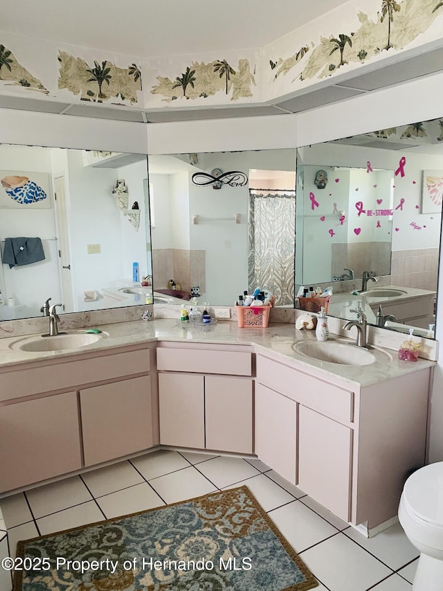 bathroom featuring tile patterned floors, vanity, and toilet