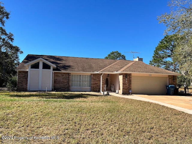 ranch-style house featuring a garage and a front lawn