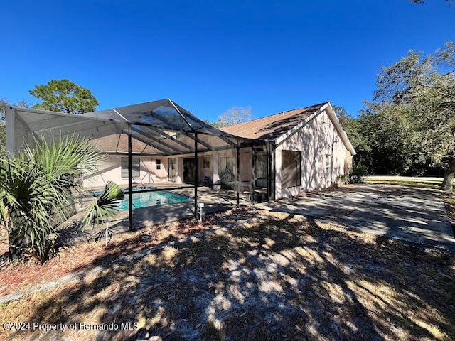 back of house featuring a lanai