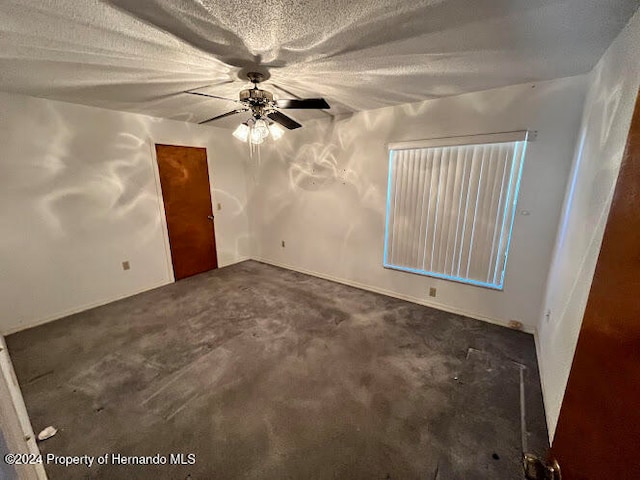 unfurnished room featuring a textured ceiling