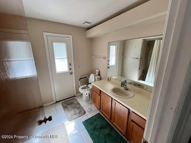 bathroom with tile patterned floors, vanity, and toilet