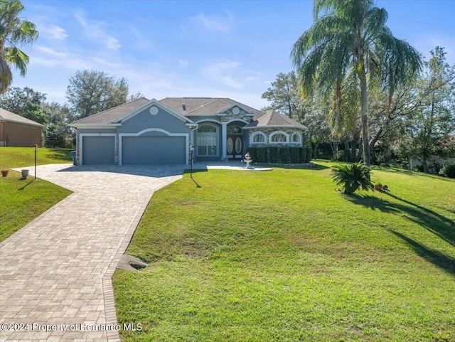 view of front of house with a front lawn and a garage