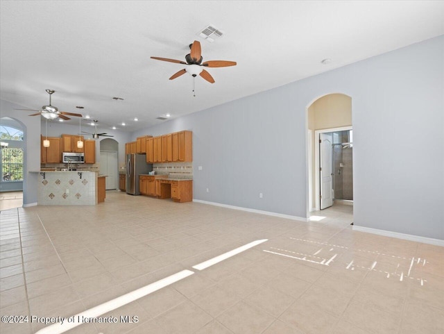 unfurnished living room with ceiling fan and light tile patterned flooring