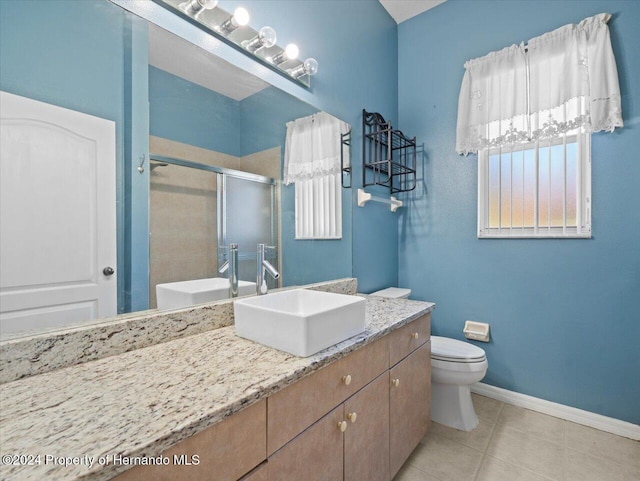 bathroom with tile patterned floors, toilet, an enclosed shower, and vanity