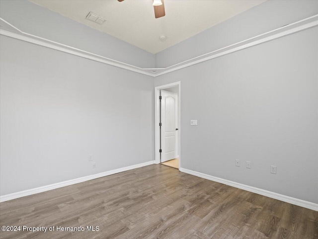 unfurnished room featuring ceiling fan and hardwood / wood-style floors