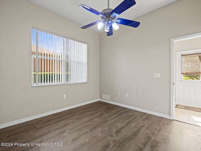 empty room featuring ceiling fan and dark wood-type flooring