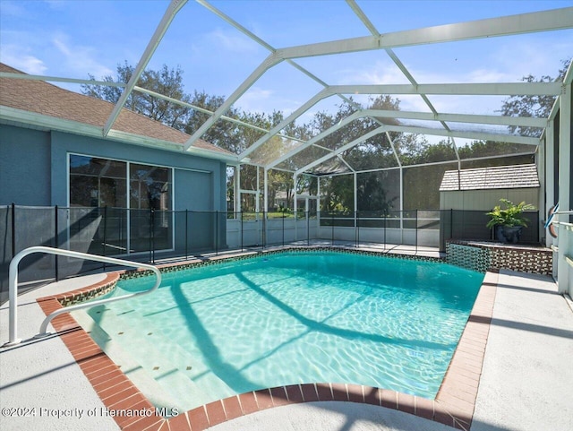 view of swimming pool with a lanai and a patio