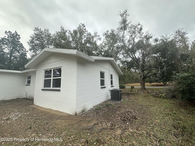 view of side of property with central AC unit