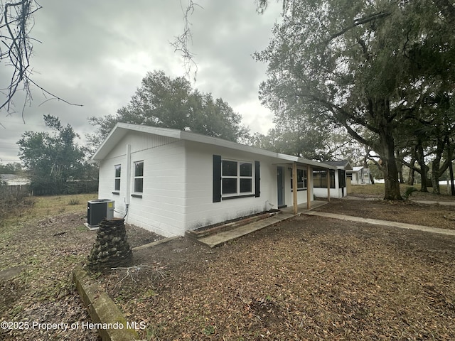 view of front of house with a porch and central AC