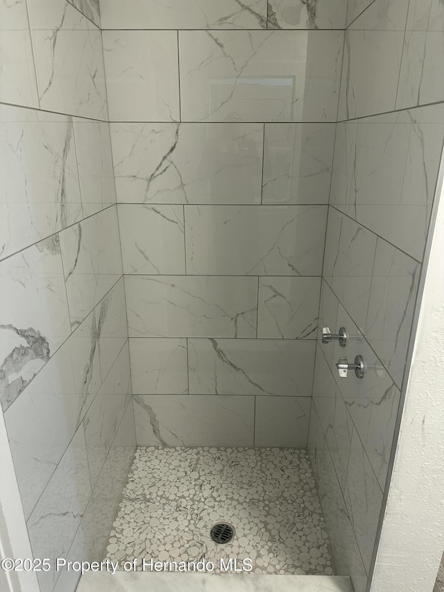 bathroom with tiled shower