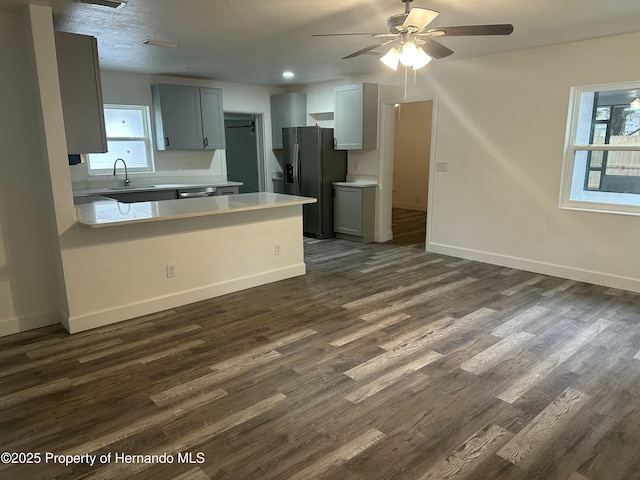 kitchen featuring sink, appliances with stainless steel finishes, gray cabinets, and dark hardwood / wood-style flooring