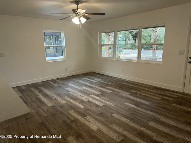 empty room featuring ceiling fan and dark hardwood / wood-style floors