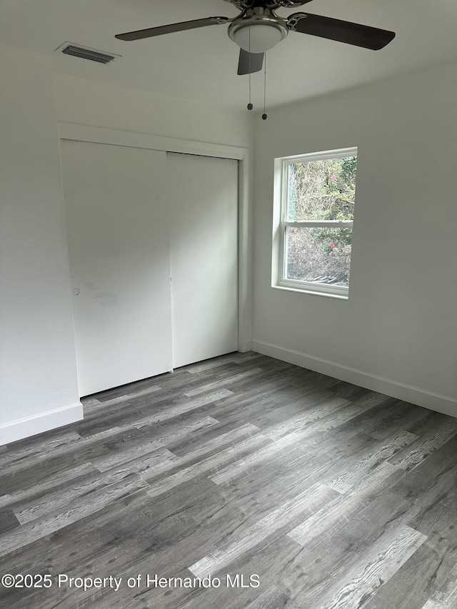 spare room featuring ceiling fan and hardwood / wood-style floors