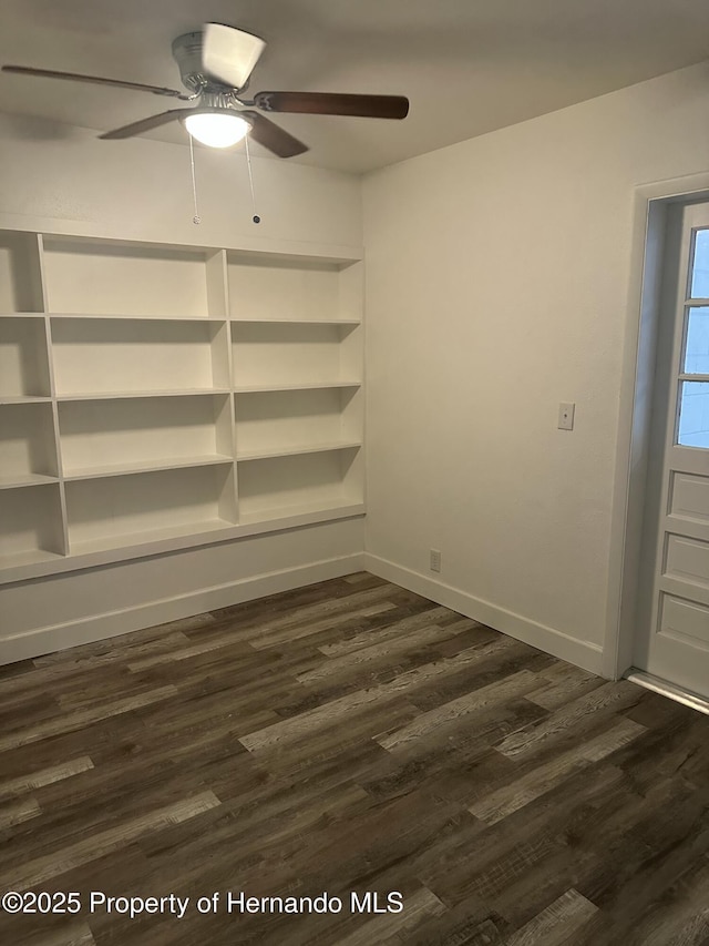 spare room with ceiling fan and dark hardwood / wood-style flooring