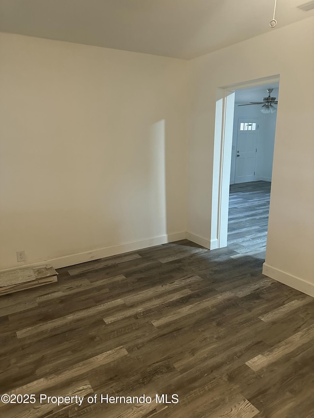 unfurnished room featuring ceiling fan and dark hardwood / wood-style floors