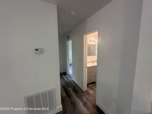 corridor with sink and dark hardwood / wood-style floors