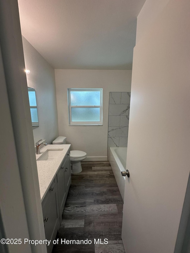 bathroom featuring toilet, hardwood / wood-style floors, and vanity