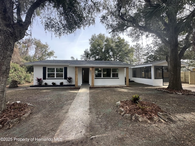 single story home featuring a sunroom