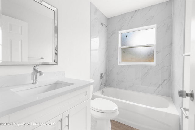 bathroom featuring toilet, shower / tub combination, wood finished floors, and vanity