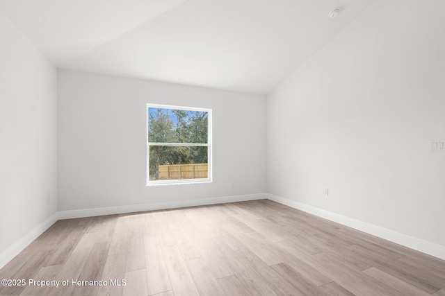 empty room featuring light wood finished floors and baseboards