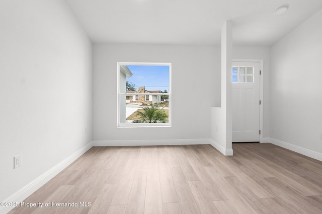 interior space featuring light wood-style flooring and baseboards