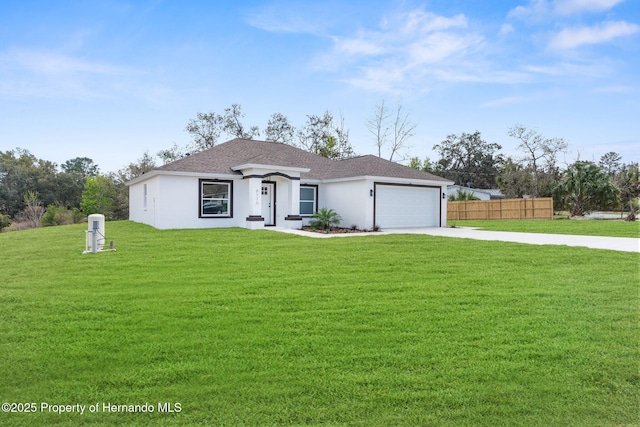 view of front of house with a garage, fence, driveway, stucco siding, and a front yard