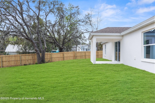 view of yard featuring a patio area and a fenced backyard