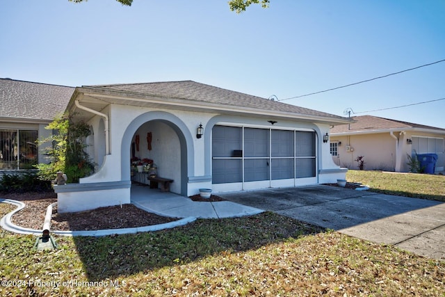 view of front facade with a front lawn and a garage