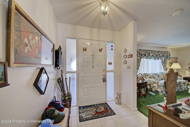 tiled entrance foyer with a textured ceiling