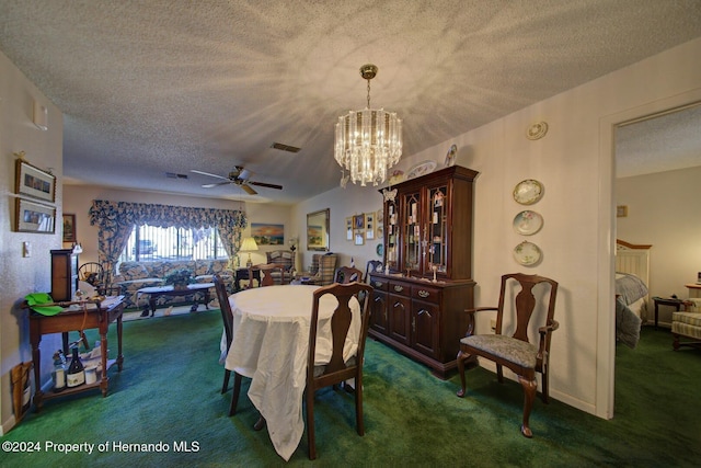 dining space featuring ceiling fan with notable chandelier, dark carpet, and a textured ceiling