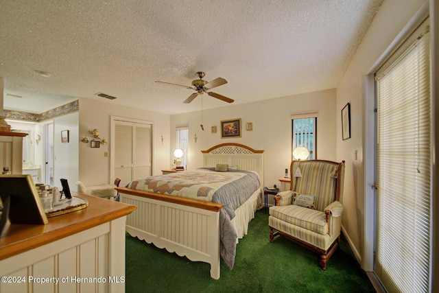 bedroom featuring carpet, a textured ceiling, a closet, and ceiling fan