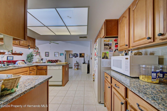 kitchen with ceiling fan, sink, light stone countertops, white appliances, and light tile patterned floors