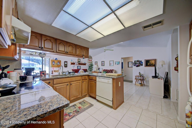 kitchen featuring lofted ceiling, white dishwasher, sink, ceiling fan, and kitchen peninsula