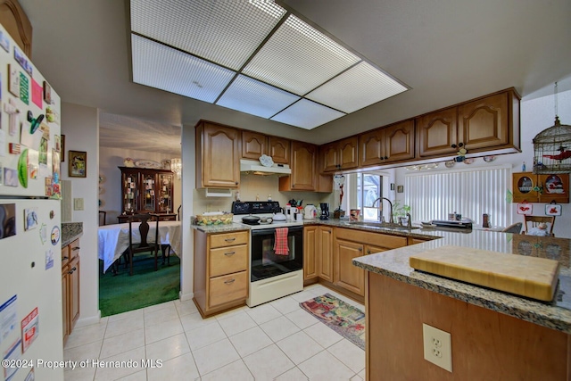 kitchen featuring light tile patterned floors, white appliances, and sink