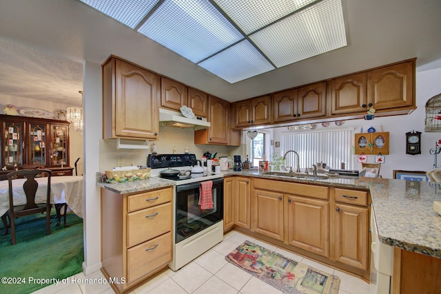 kitchen featuring light stone counters, sink, light tile patterned flooring, and white electric range