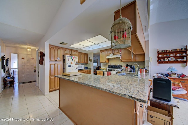 kitchen with lofted ceiling, white appliances, sink, light stone countertops, and kitchen peninsula