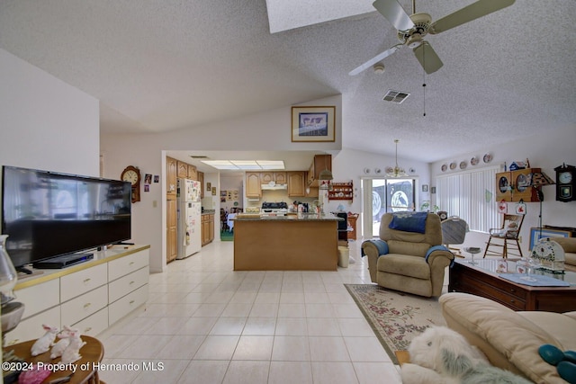 living room with ceiling fan, light tile patterned flooring, lofted ceiling, and a textured ceiling