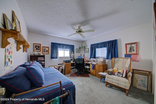 bedroom with ceiling fan, carpet, and a textured ceiling