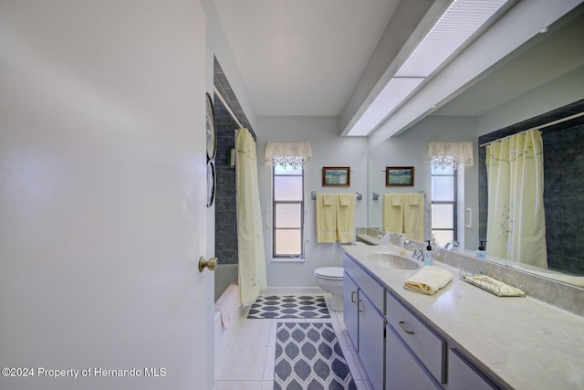 full bathroom featuring tile patterned floors, vanity, shower / bath combination with curtain, and toilet