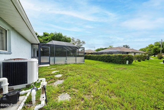 view of yard featuring glass enclosure and cooling unit