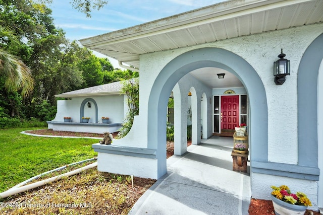 doorway to property with a yard