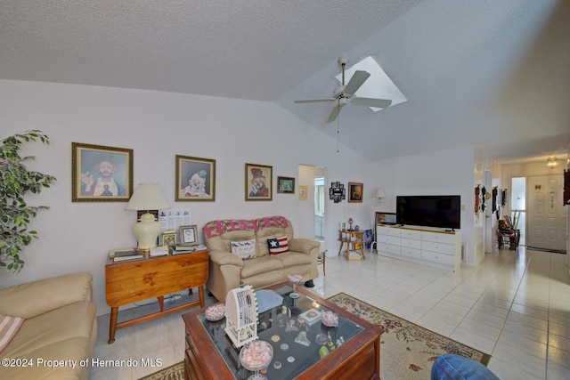 living room featuring ceiling fan, lofted ceiling, and light tile patterned floors