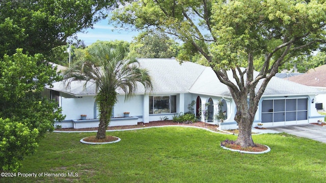 view of front of home with a garage and a front lawn